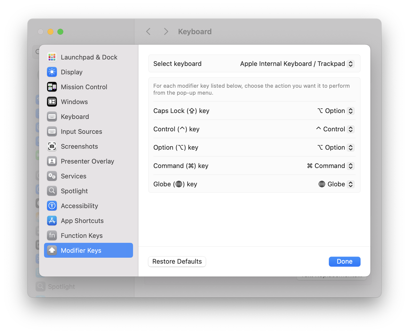 Changing Caps Lock to Option key in macOS keyboard settings.